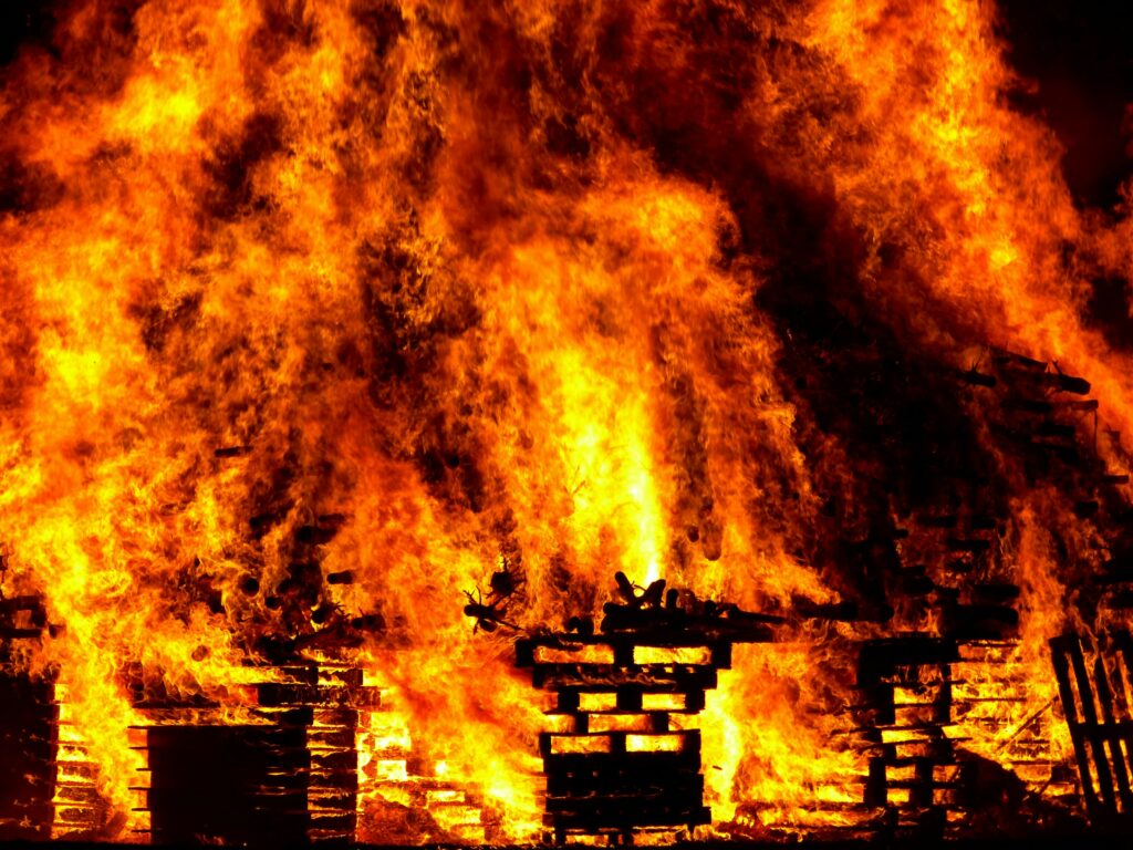 A large pile of burning pallets